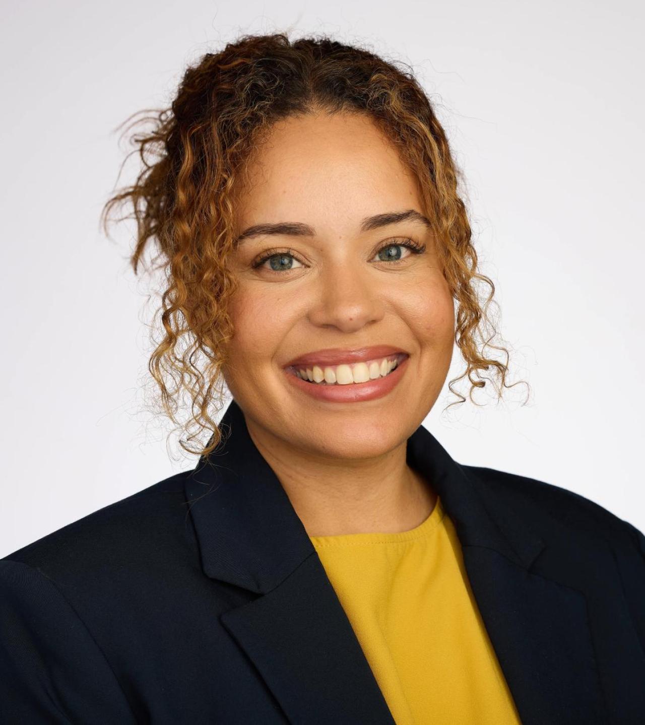 Ashley Caceres smiling in headshot