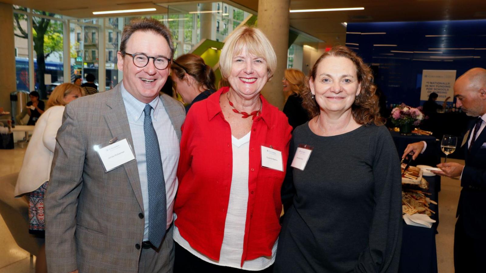 three individuals posing at conference