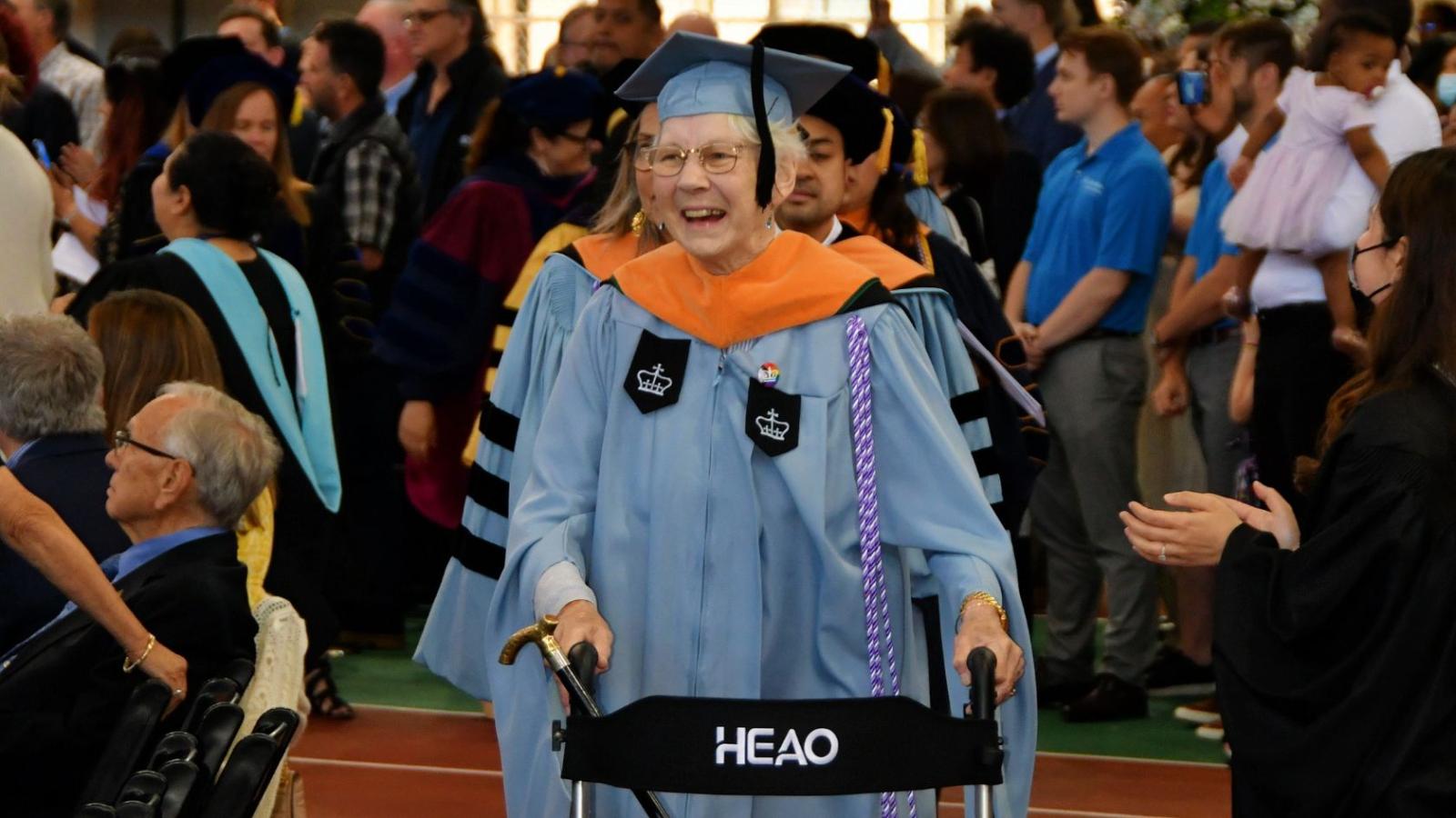 Instructor Mary Moran walking in to the graduation ceremony