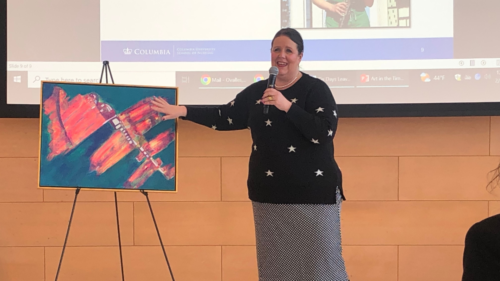 Woman pointing to canvas in event setting