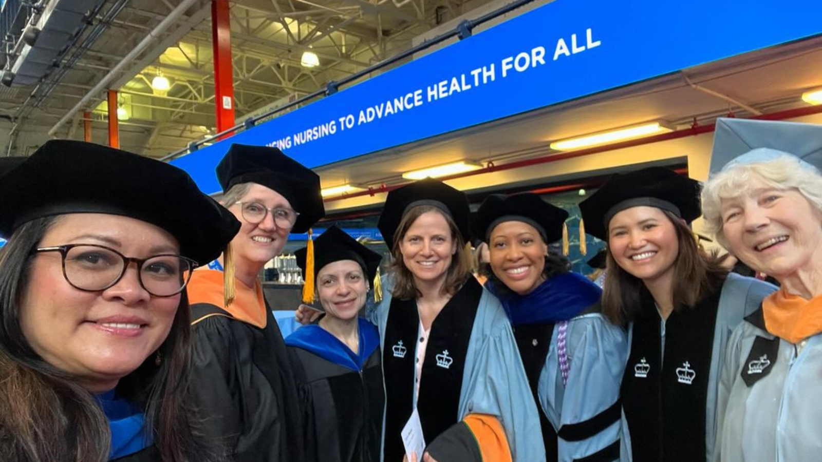 Columbia Nursing faculty posing with graduates