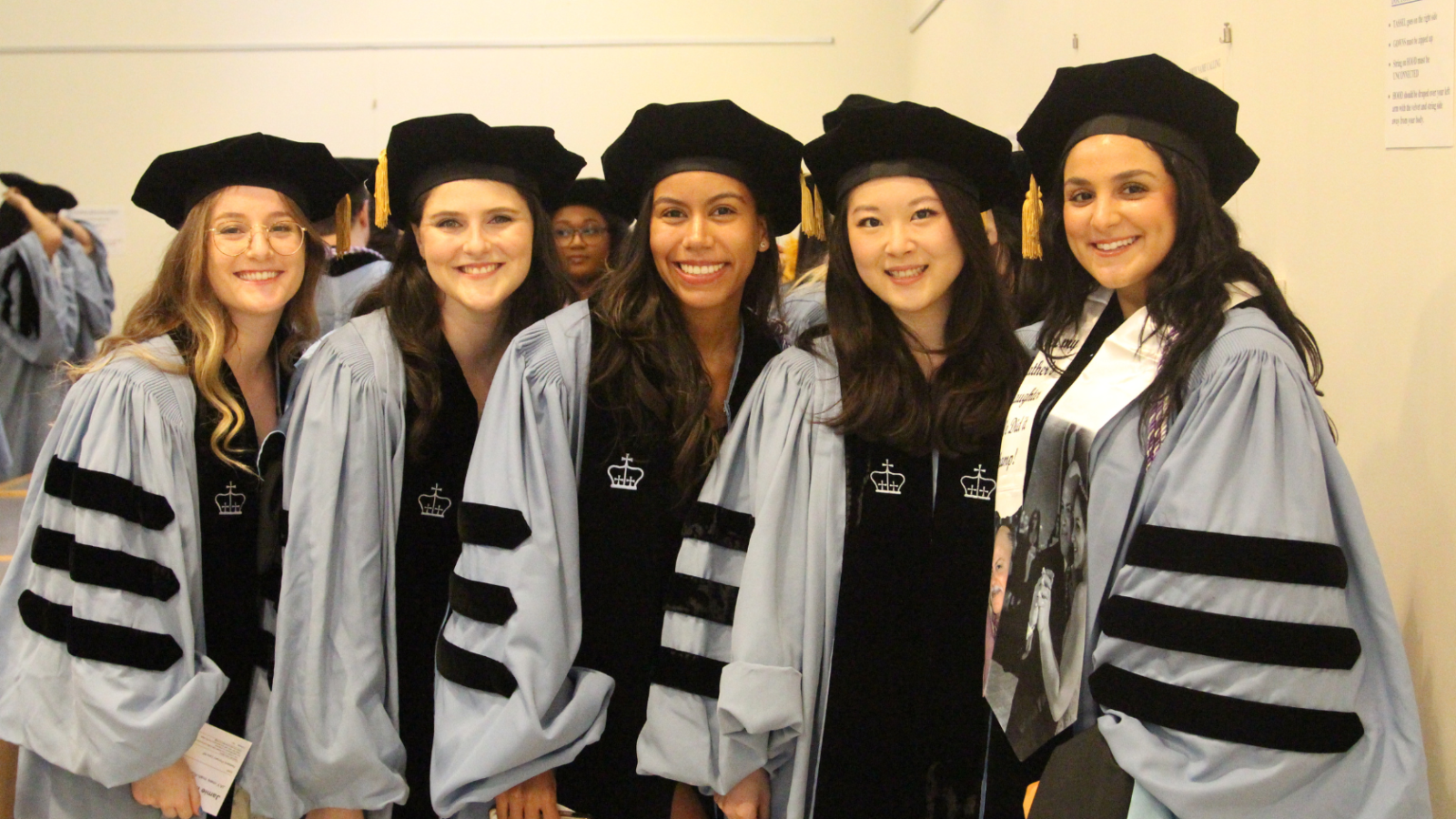 Five graduates in their regalia