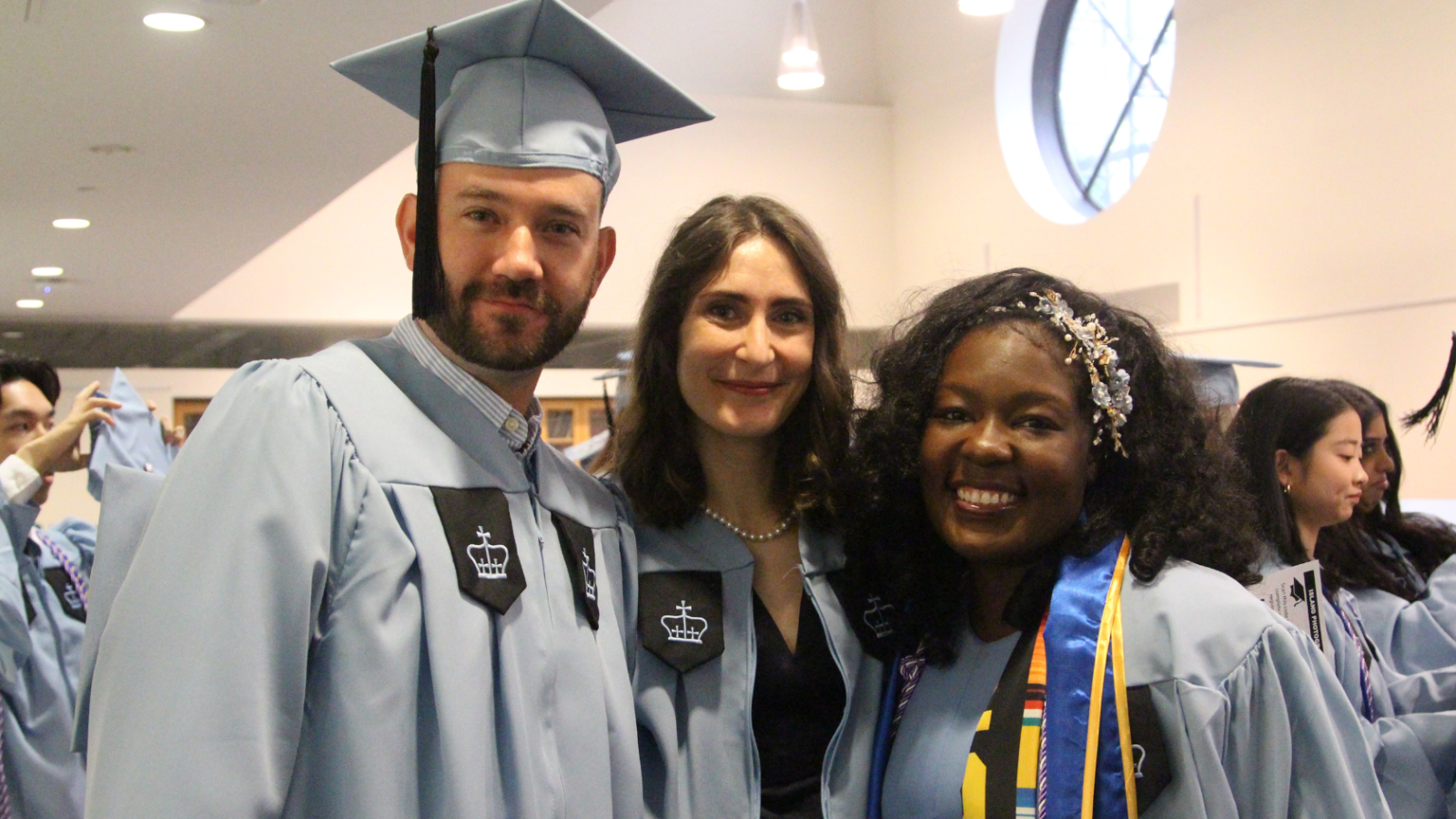 one male graduate and two female graduates before ceremony