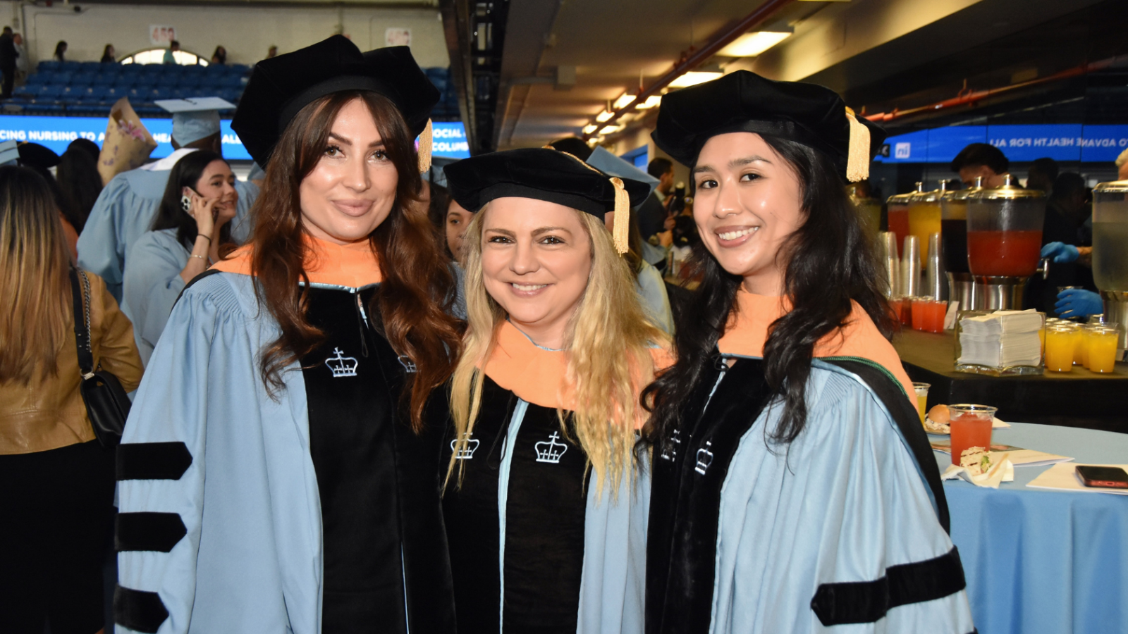 three graduates in their regalia