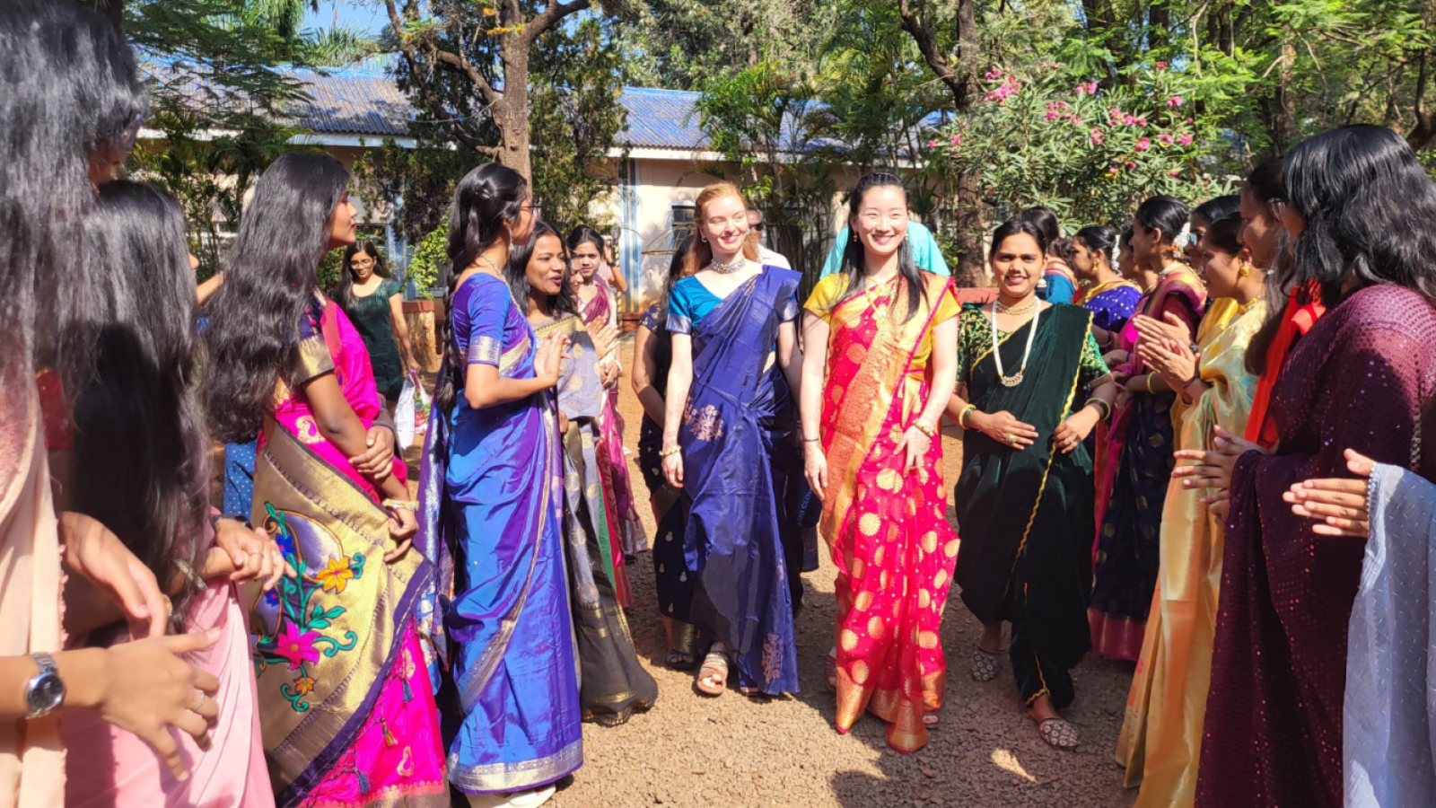 Columbia Nursing in local dress in crowd gathering