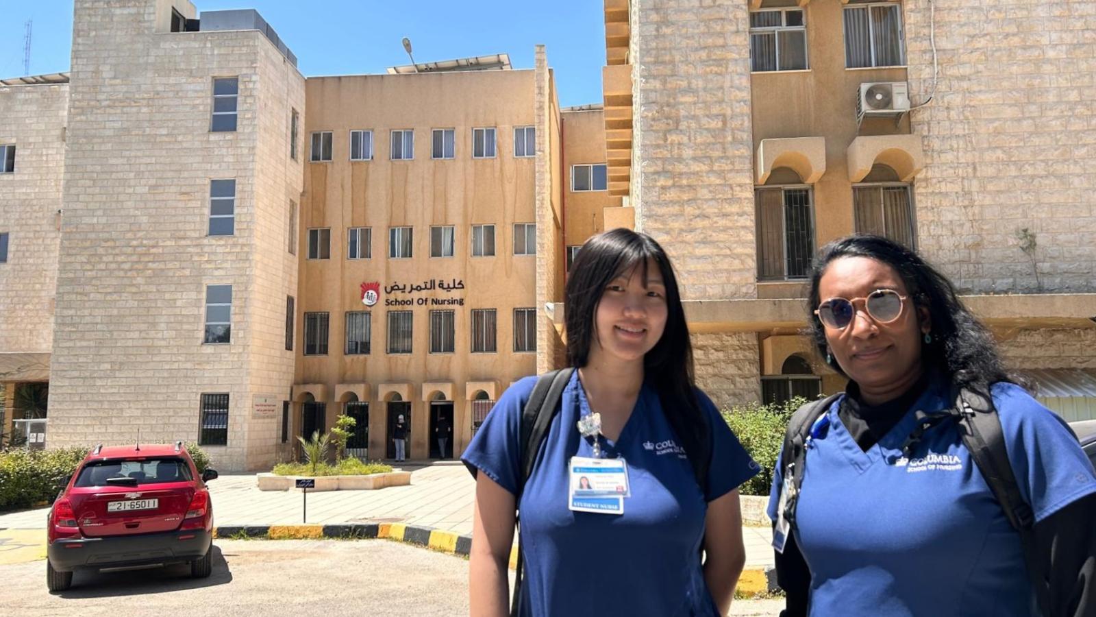 Two Columbia Nursing students standing outside hospital