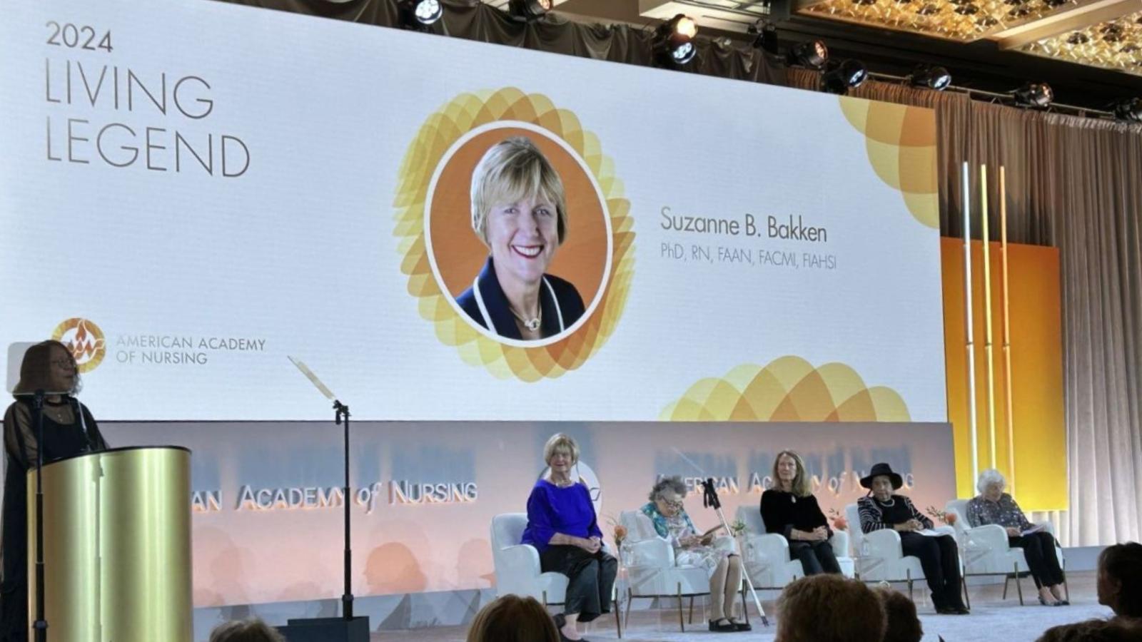 Professor Bakken receiving award on stage