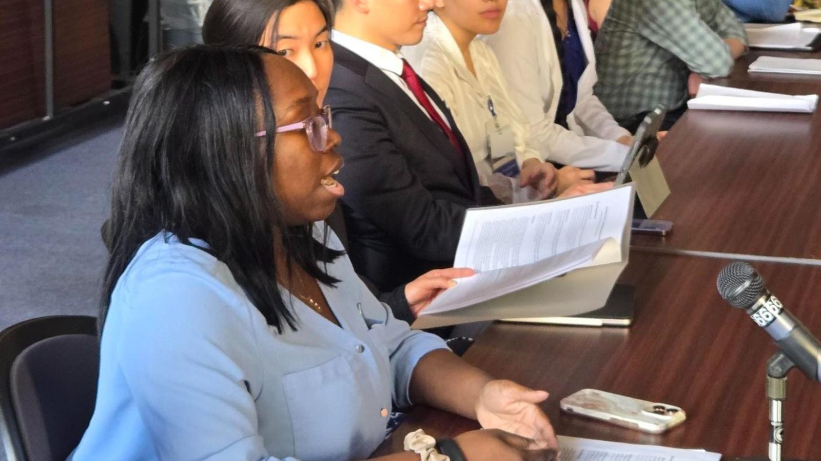 Columbia Nursing student making statement in front of microphone