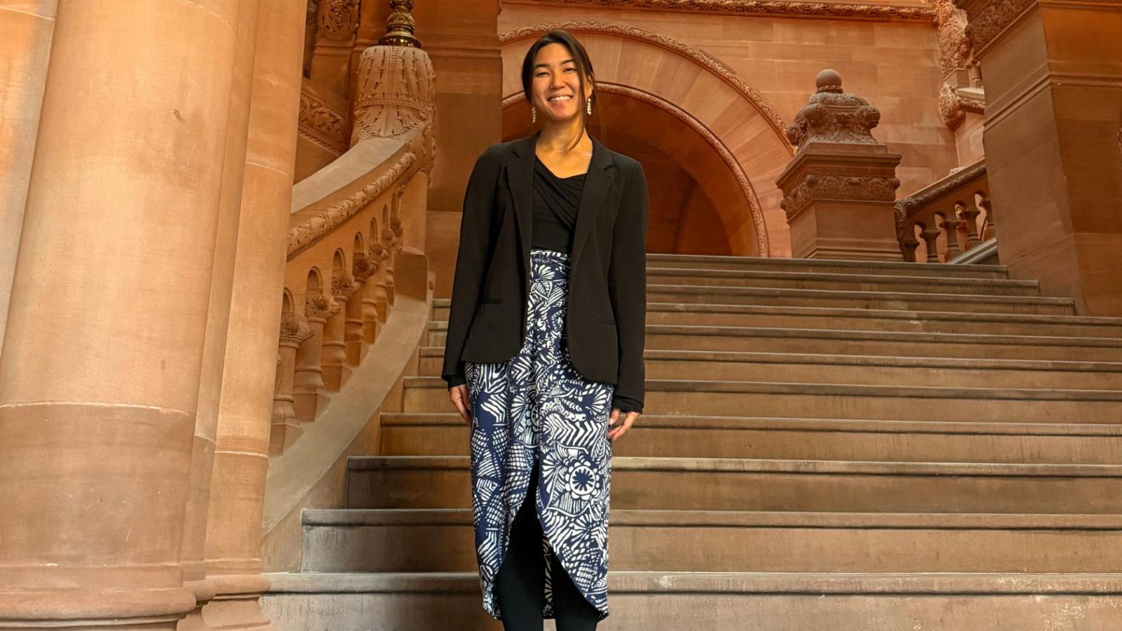 Columbia Nursing student standing on stairs in government buildling
