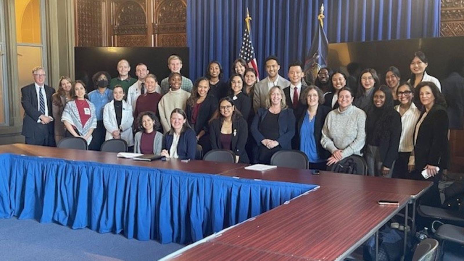 Group photo of Columbia students standing in government building