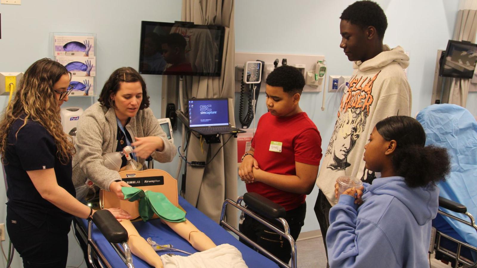 Columbia Nursing students teaching young middle school students in simulation lab
