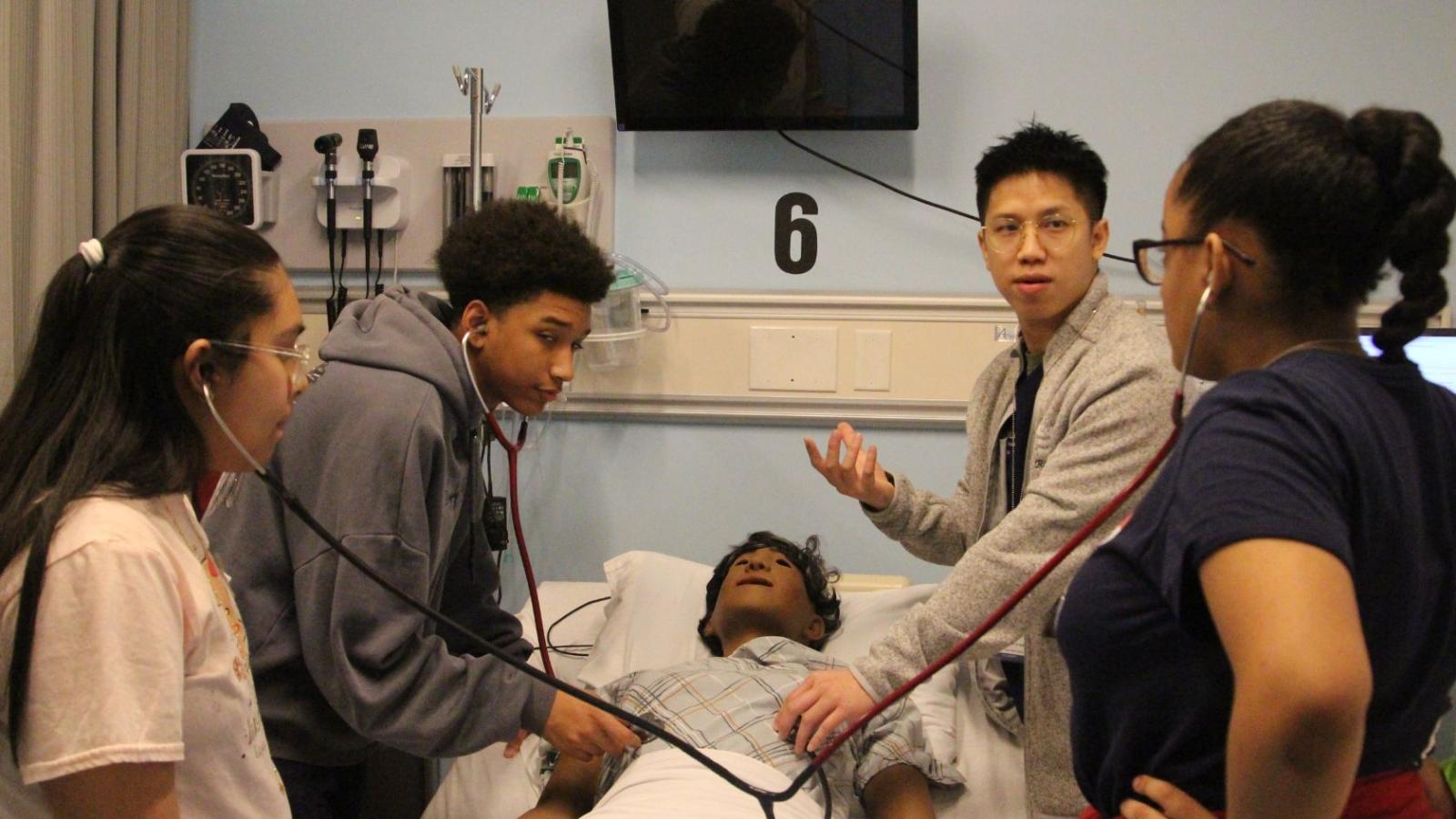 Columbia Nursing students teaching young middle school students in simulation lab