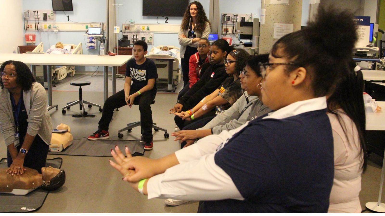 Columbia Nursing students teaching young middle school students in simulation lab