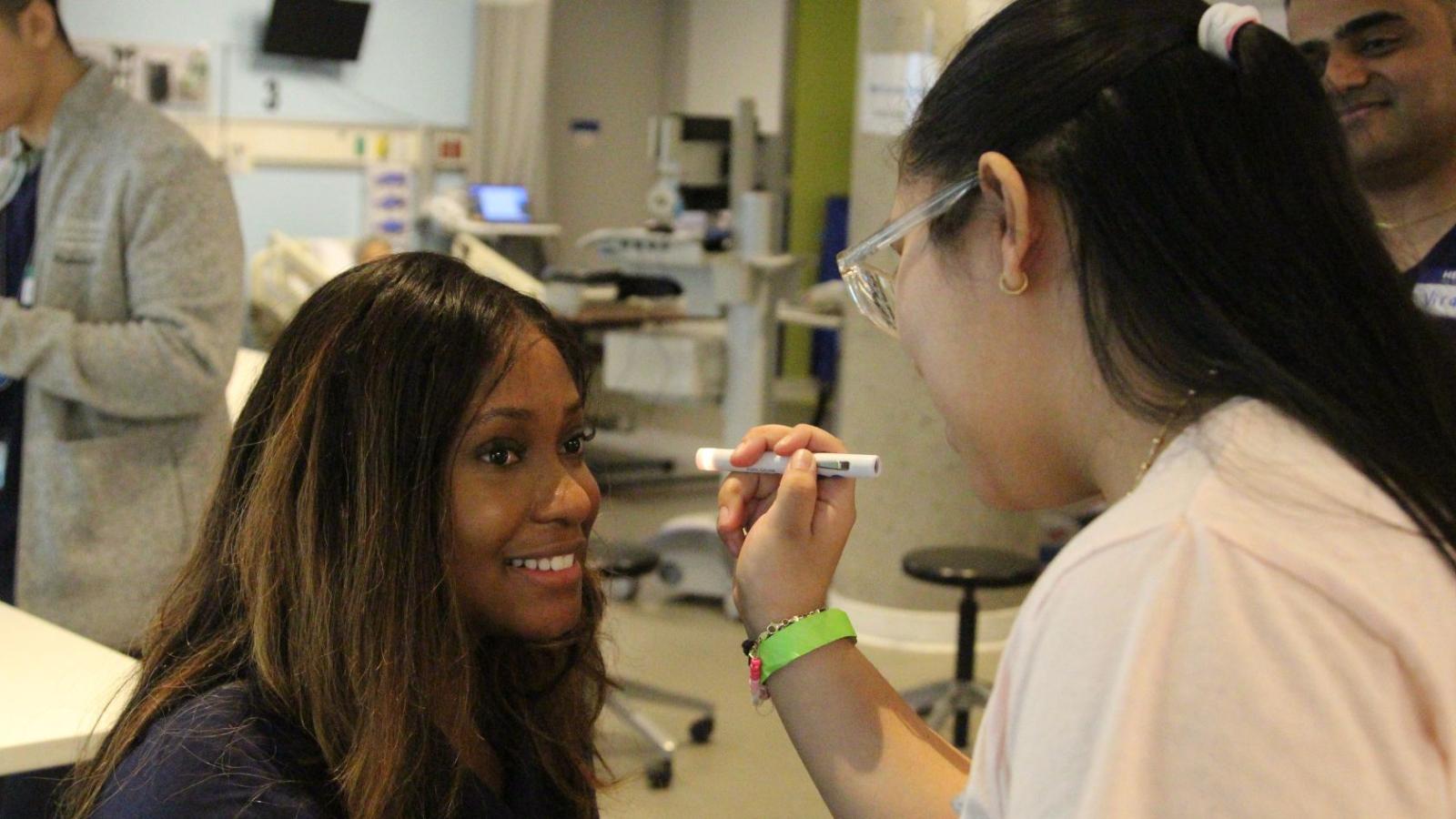 Columbia Nursing students teaching young middle school students in simulation lab