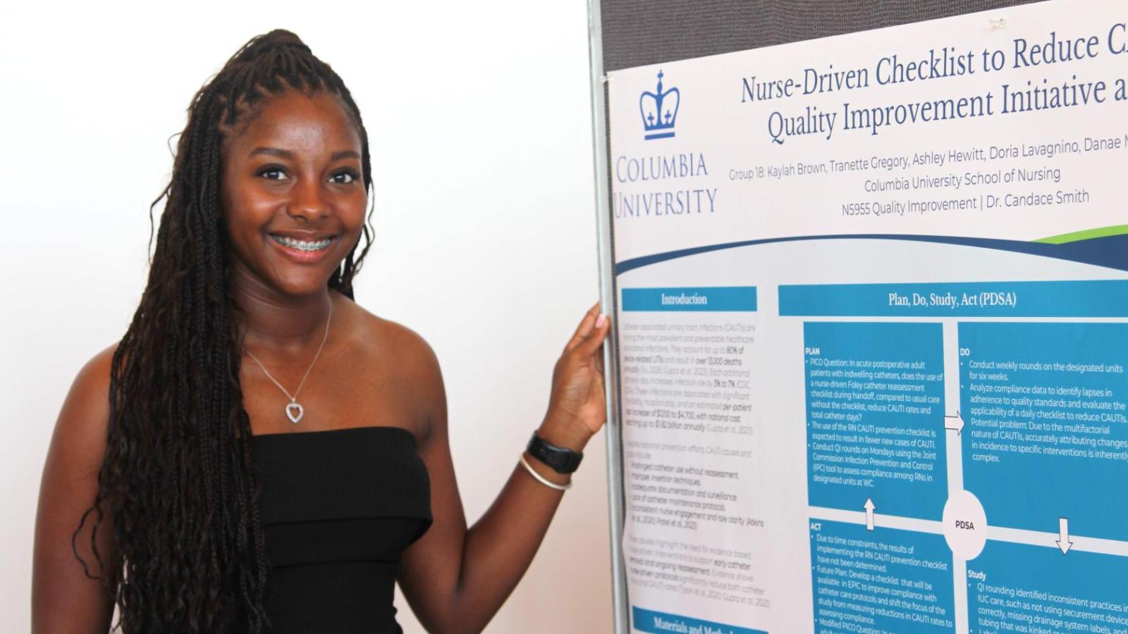 Student poses at 2025 QI Poster Session