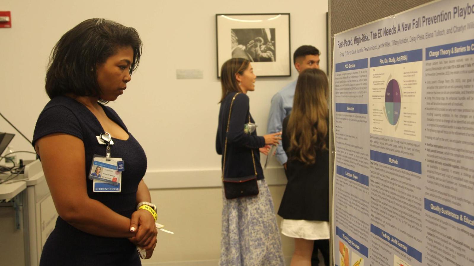 Attendee reviewing poster at 2025 QI poster session