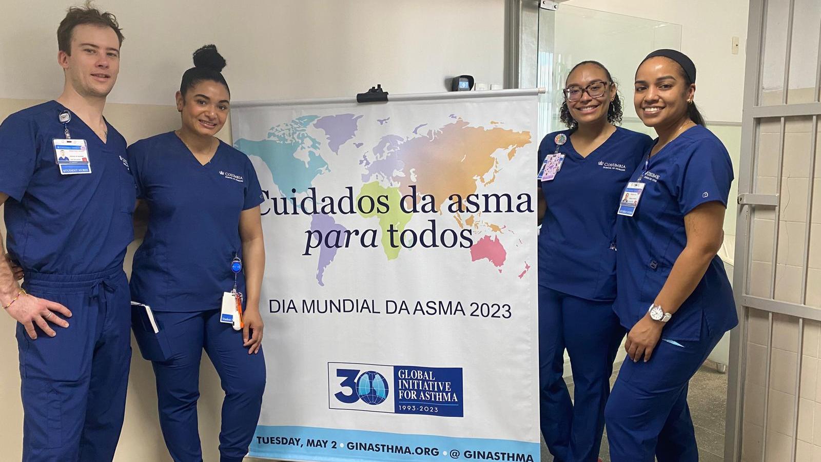 fours students in front of sign.