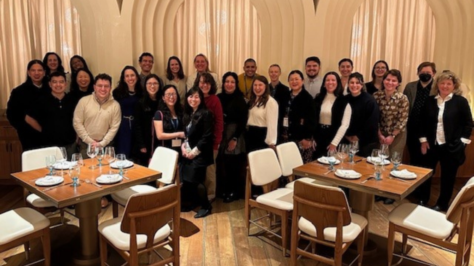 Columbia Nursing PhD students pose for group photo in low-lit restaurant