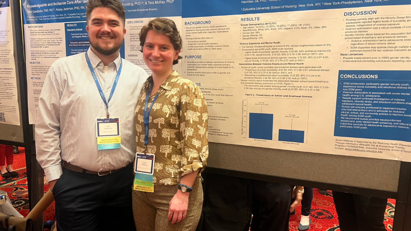 Two students pose with their poster presentation