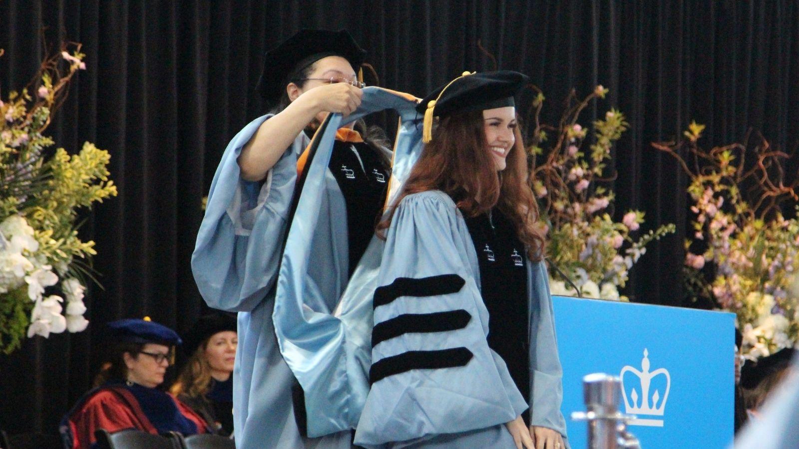 A DNP graduate receives her hood