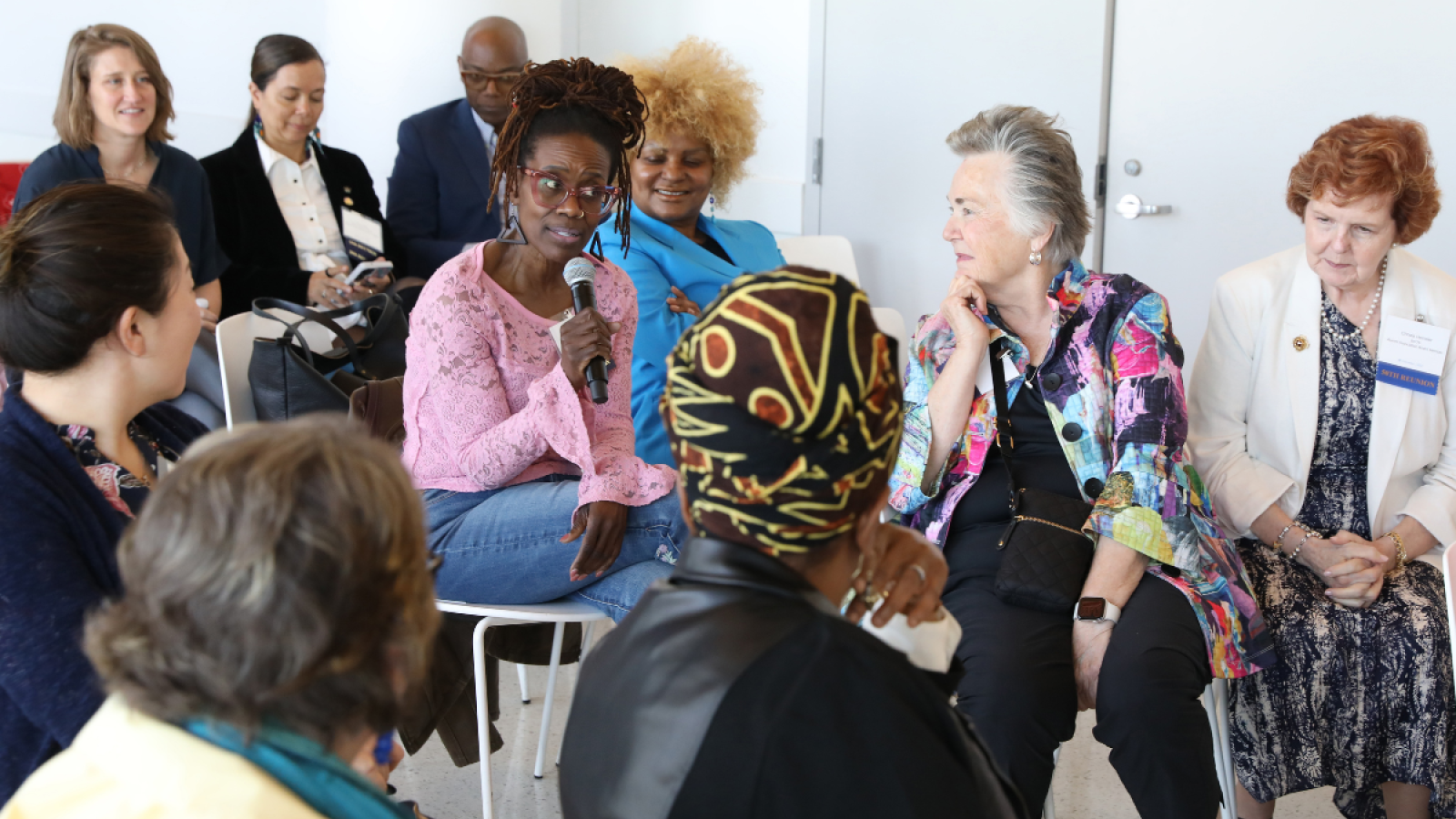 Columbia Nursing alumni speaking into a microphone during a group discussion