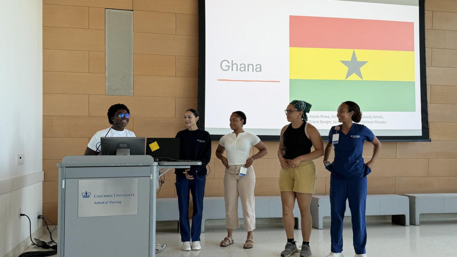 Students who went to Ghana speak at podium