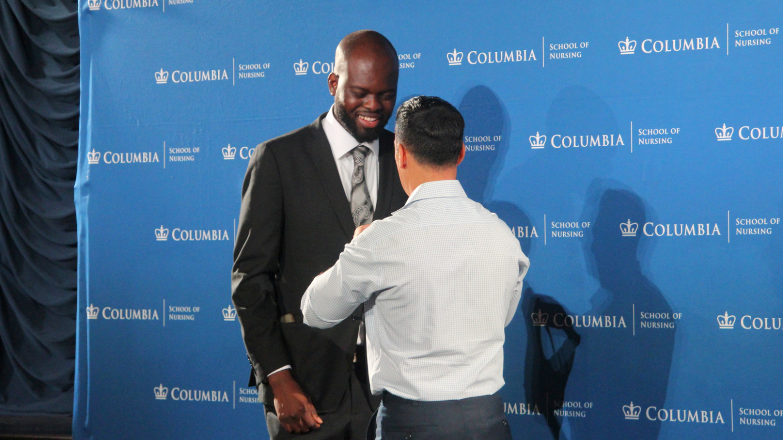 An MDE student celebrating being pinned