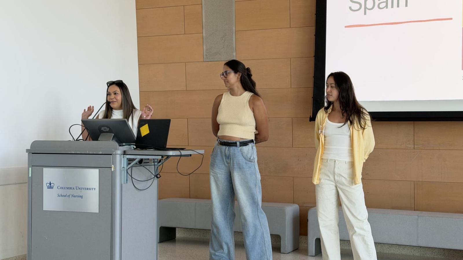 Students who went to Spain speak at podium