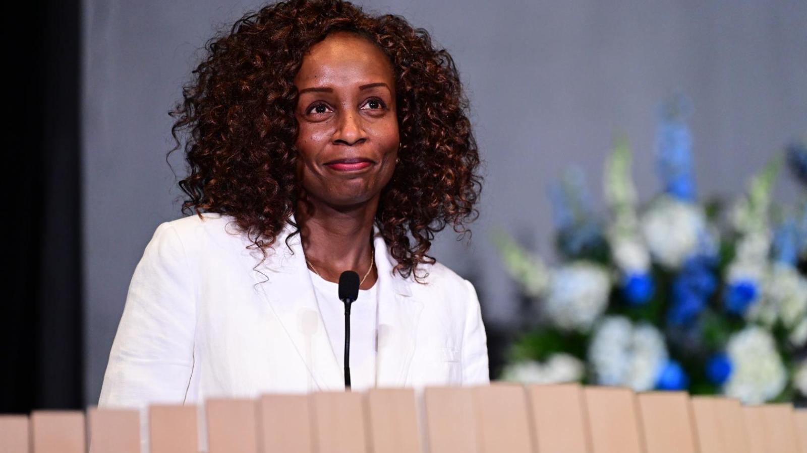 Alumni speaker at podium during 2026 White Coat Ceremony