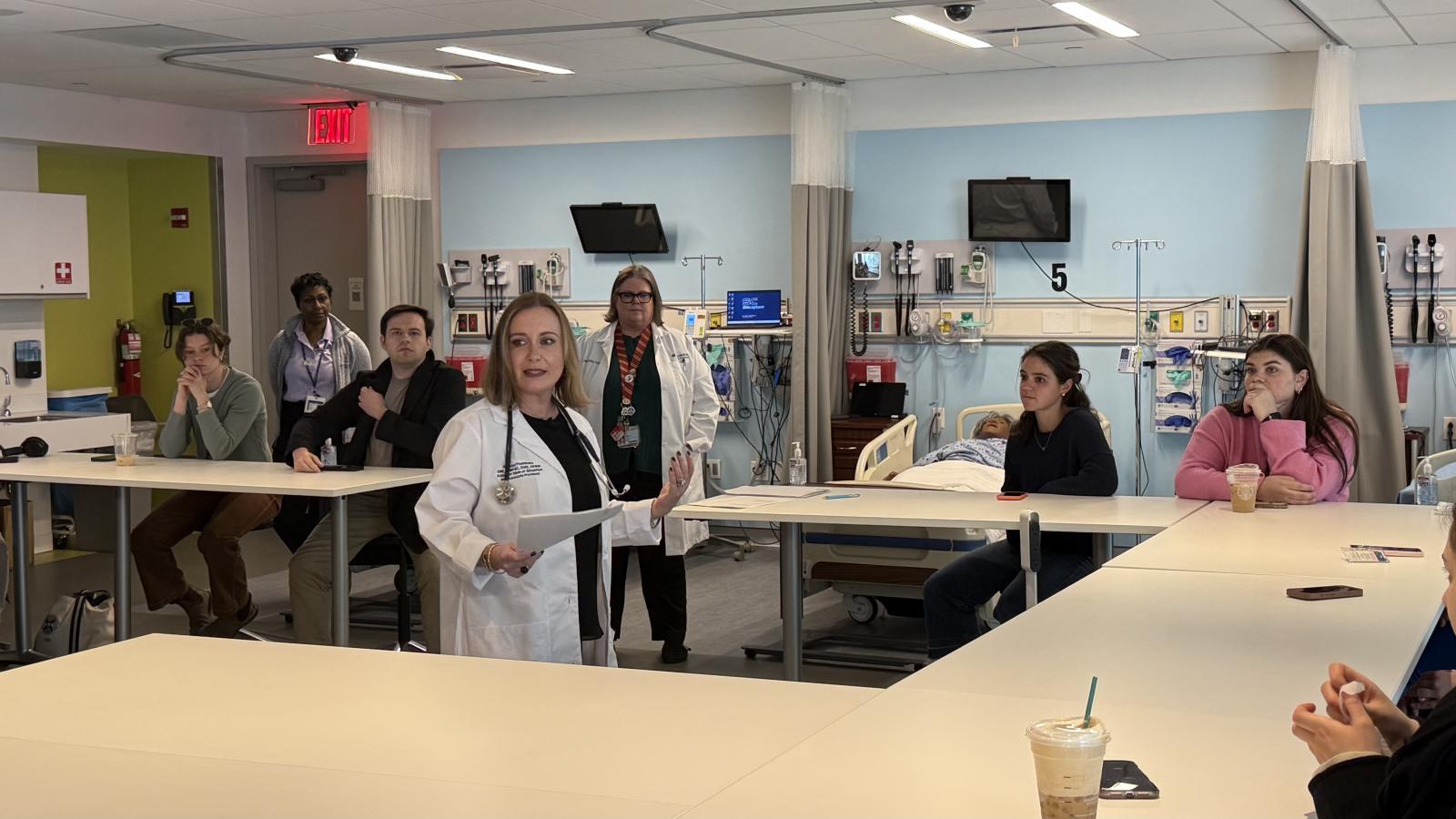 Simulation instructor speaking to students at IPE Day