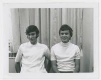 black & white photo of  two male students sitting down and smiling