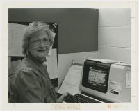 black & white photo of Dean Jamann-Riley at a computer