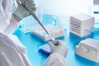 Lab scene with tech using pipette and test tube