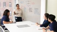 Columbia Nursing academic coach working with students in a classroom.