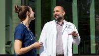 Two nursing students talking outside Columbia Nursing building.