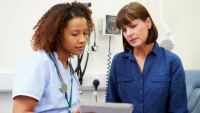 Nurse consulting with patient.