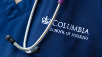 Close up of Columbia Nursing logo on scrubs with stethoscope.