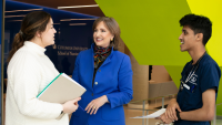 Dean Frazier speaking with two nursing students in Columbia Nursing's lobby.
