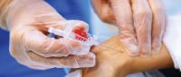 nurse taking blood from patient