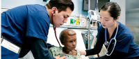 two students work with manikin