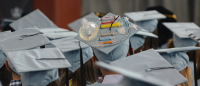 Close up of graduation caps at ceremony.