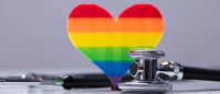 Rainbow heart next to stethoscope.