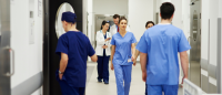 Nurses walking through hall.