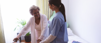 Nurse helping resident.