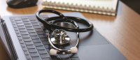 Stethoscope on a laptop.