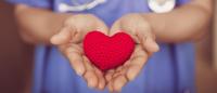 Nurse holding heart in hands