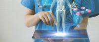 Nurse with tablet, visualizing AI