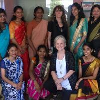 Group of women standing and kneeling.